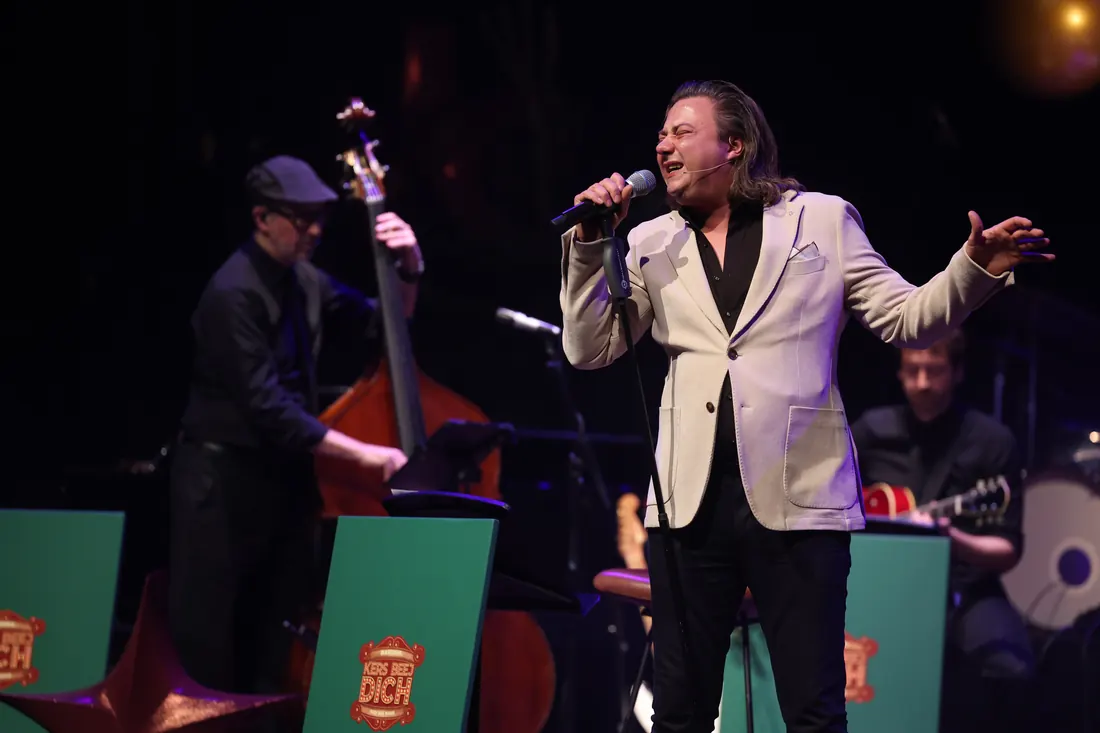 Marinho Peters zingt op het podium van Kers Beej Dich, met de contrabassist van de KBD Big Band